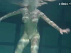 TitsCult presents: Naked brunette with big tits swims solo