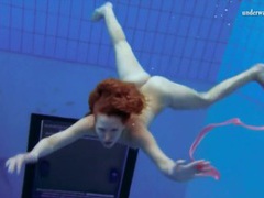 TitsCult presents: Curly hair redhead swims and looks sexy