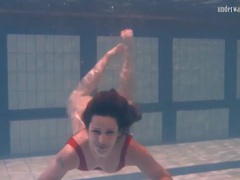 TitsCult presents: Swimming brunette in one piece swimsuit