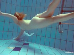 TitsCult presents: Redhead goes for a nude swim in the pool